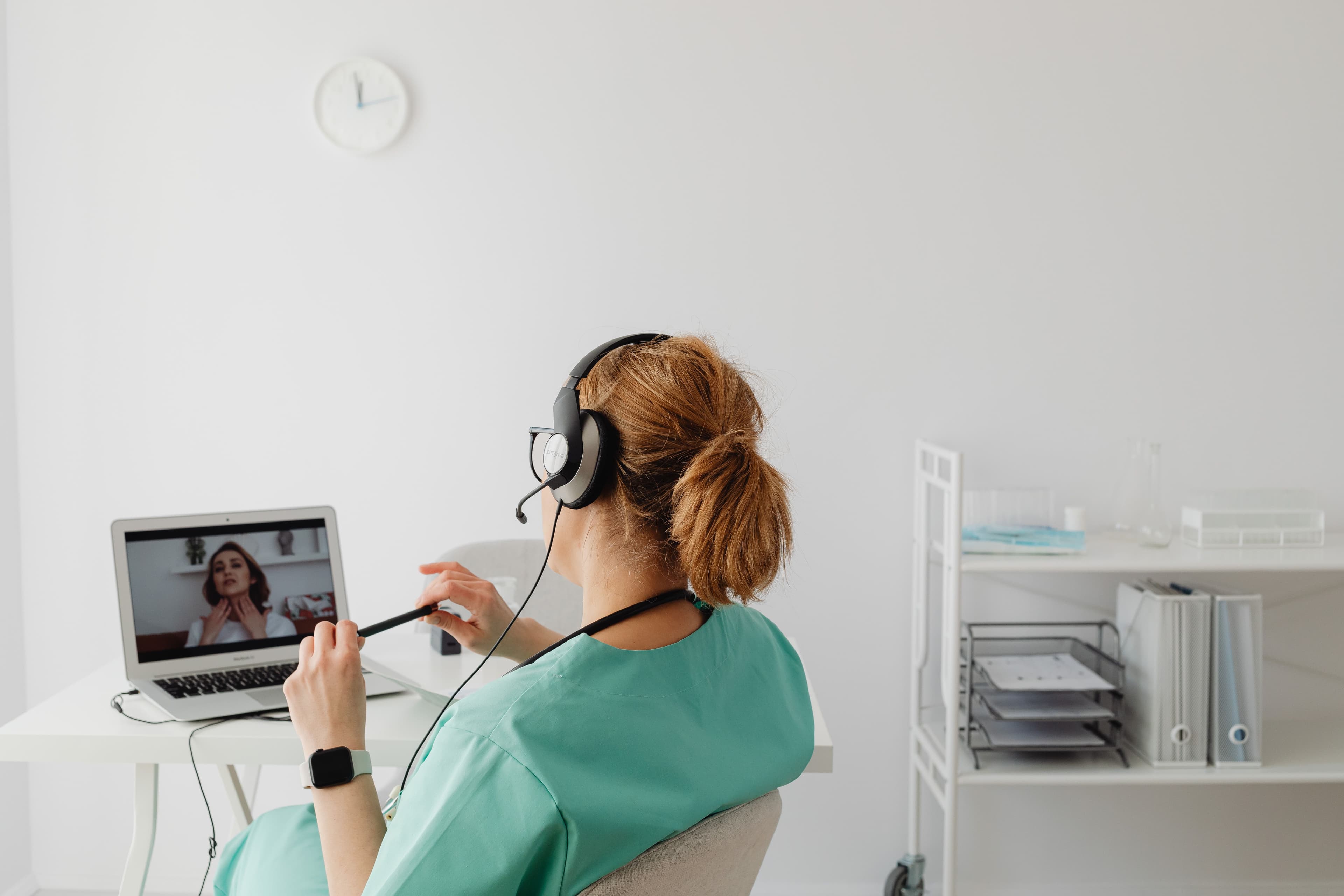 Healthcare practitioner conducting a telehealth consultation on a laptop